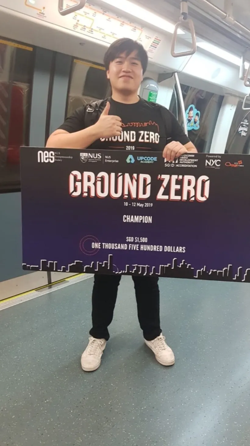 Joshua Lim holding the SGD 1,500 champion cheque for NES Ground Zero 2019